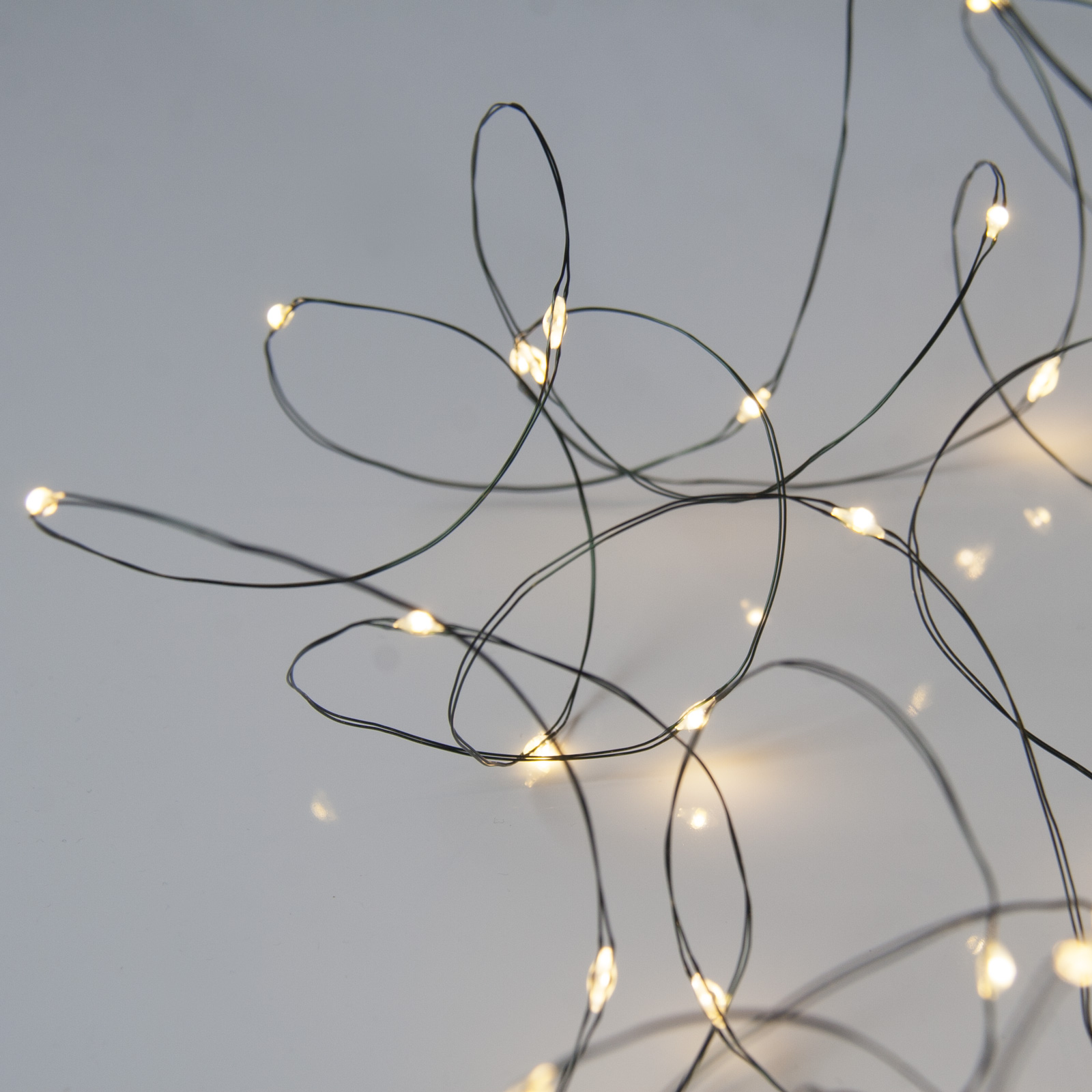 60 Warm White Battery Powered Fairy Lights on Green Wire. Multifunction